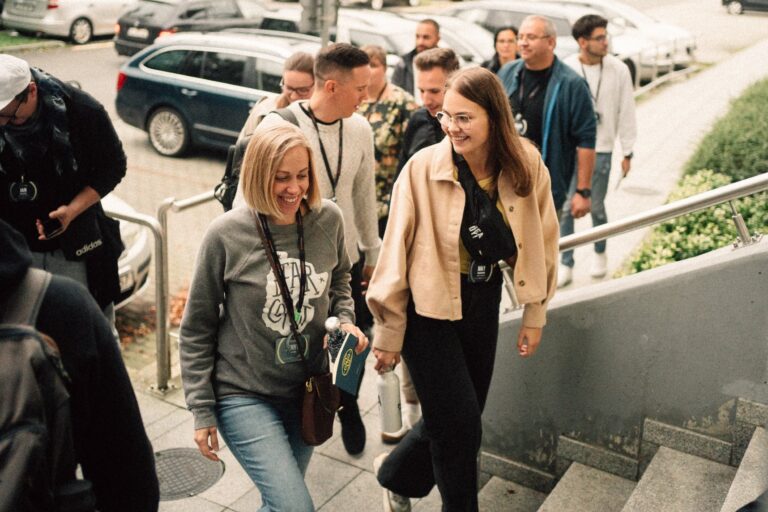 People wearing name tags walk up stairs